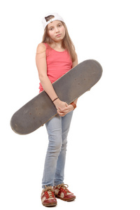 时尚与滑板的漂亮的小女孩