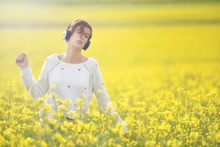 年轻美丽的黑发女人女孩听音乐的耳机