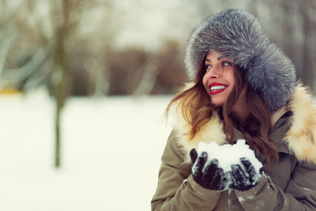 美丽的女人，在冬天的外套和毛皮帽子
