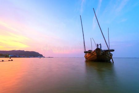 随着夕阳的天空,破船飞过大海照片