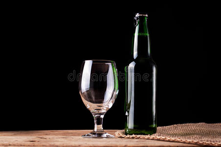 木制桌子上有啤酒的玻璃和瓶子