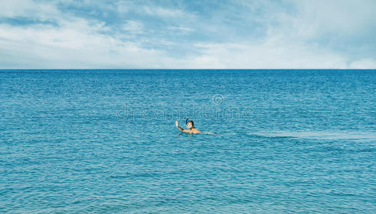 女孩在海里戴着面具浮潜