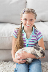 可爱的女孩抱着兔子在生活区