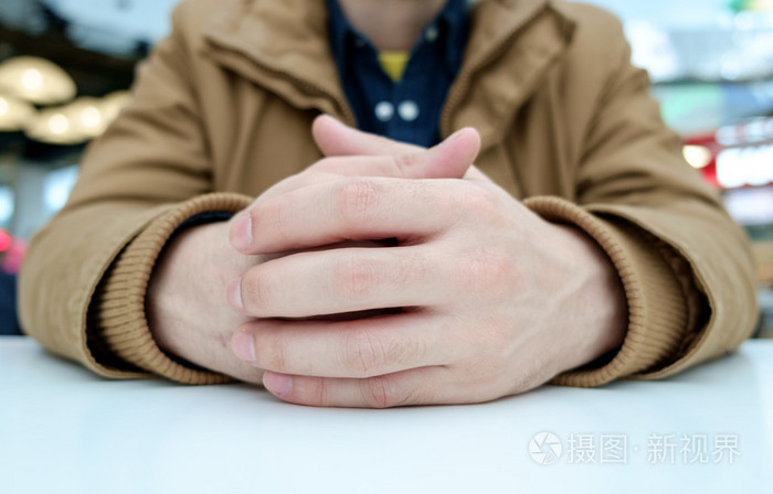 交叉手指的男人