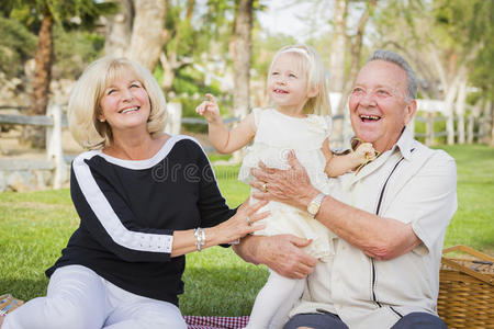 深情的孙女和祖父母在公园玩耍