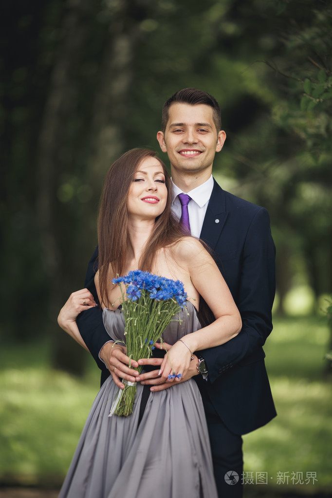 英俊的年轻夫妇,在户外仪式后合影