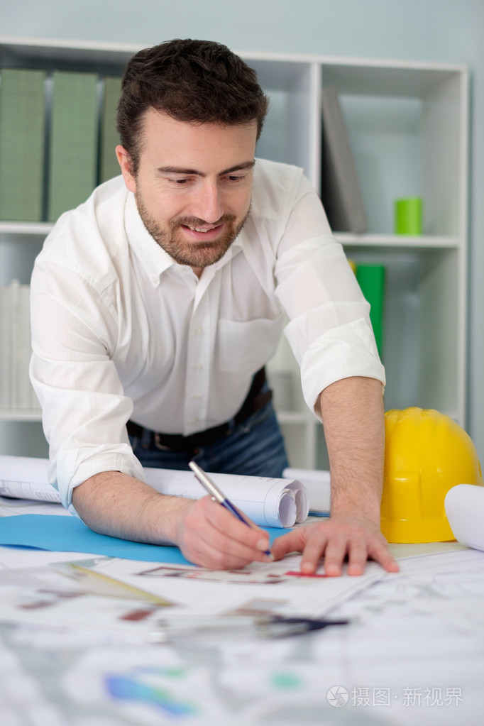 建筑师工作他的项目文件在办公室