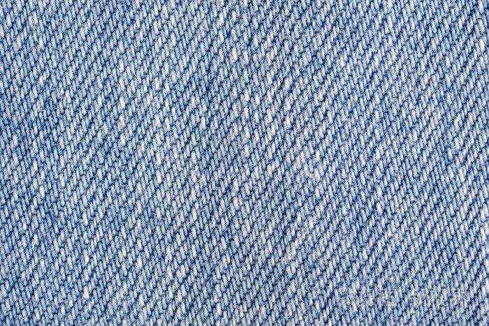 牛仔裤的背景轻便的蓝色牛仔面料肌理关闭