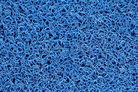 蓝色地毯或脚刮板或门垫的抽象背景。