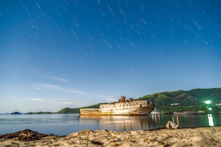 老木渔船扔进大海岸边的星空下图片