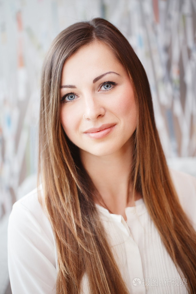 美丽微笑年轻白色高加索业务女人与蓝色的眼睛长长的金发穿着白色办公