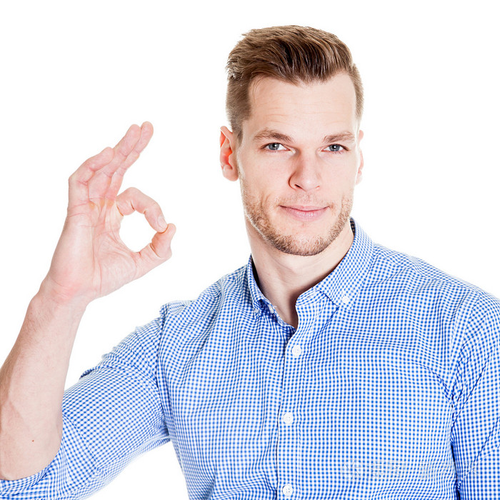 英俊的男人做ok的手势上白色孤立