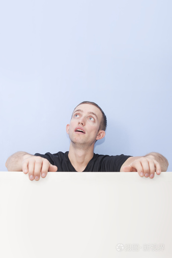 英俊的年轻男子,心不在焉地抬头照片-正版商用图片1qtjqj-摄图新视界