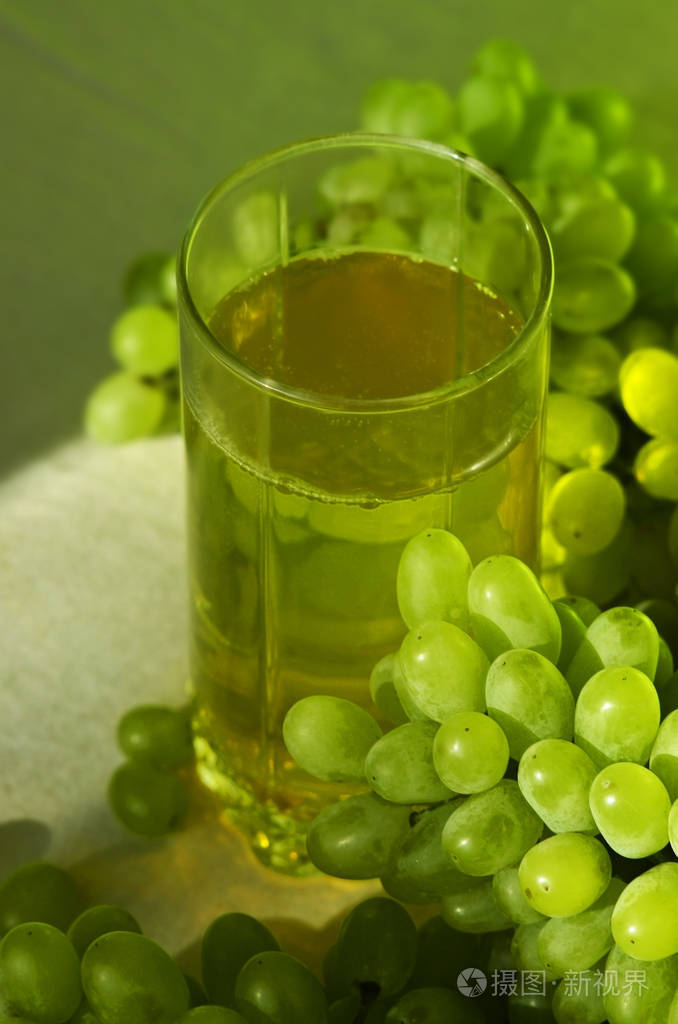 黄色葡萄汁和一束绿色葡萄