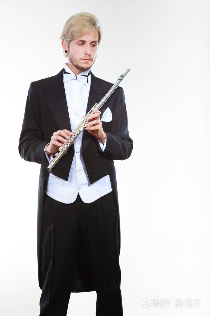 穿着燕尾服的男性长笛演奏家持有长笛