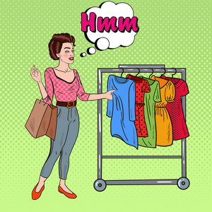 流行艺术女人与选择的新衣服的购物袋.矢量图照片