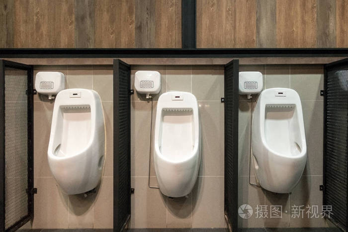 在平铺墙在公共厕所的小便池的某一行