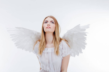 在白色翅膀的天使形象年轻, 精彩的金发女郎照片