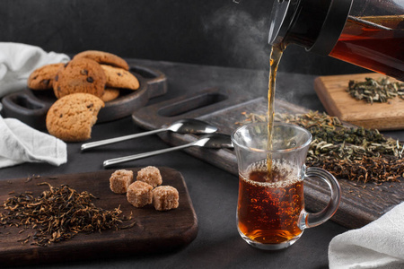 茶热气杯热气腾腾的茶,仍然生活在一个黑暗的背景照片