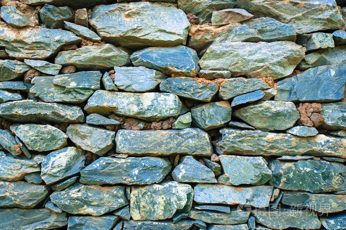堆栈的老灰色的石头墙背景或纹理