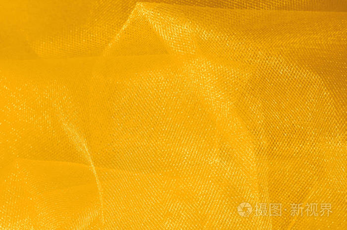 黄色丝绸织物.光滑优雅的金丝可以作为背景. 金色缎子纺织背景.