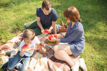 快乐的一家人在公园里吃西瓜图片