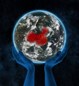 中国在地球上的夜晚,手在太空. 三维插图.照片