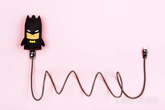 s power bank gadget on a pastel background. Like a batman toy