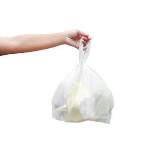 手提废塑料垃圾袋隔离白色背景手拿塑料垃圾袋倾倒垃圾照片