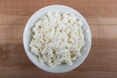 新鲜的干酪放在木制的白色碗里