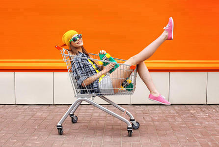 时尚潮人酷女孩与滑板在购物车