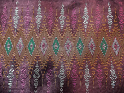 五颜六色的传统泰国旧粉红色丝绸纺织图案手工纹理复古风格