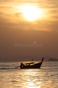 日落时海滩上的田野深处孤独的小船。