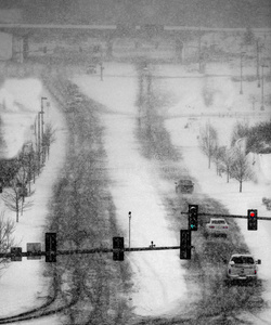 在冬天的暴风雪中开车在城里的街道上