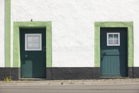 白色立面建筑和街道上的绿色门。 亚速尔群岛