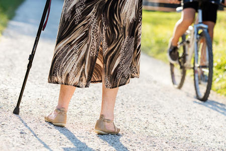 去皱纹老太太拄着拐杖走路照片