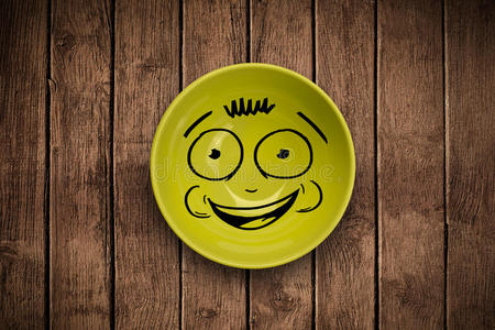 盘子卡通彩色盘子上的快乐笑脸卡通脸照片