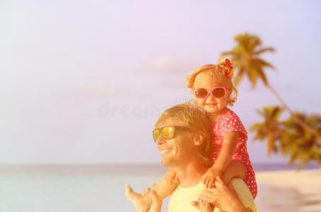 父亲和小女儿在夏天的海滩上