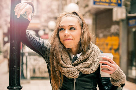 漂亮的女人在街上喝咖啡