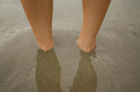 脚在沙子下面。 放松和玩耍