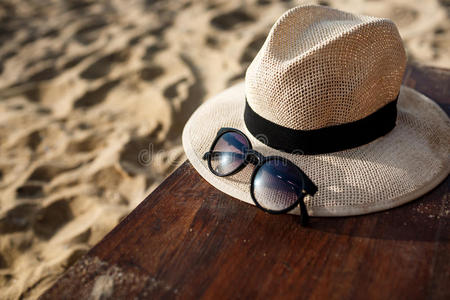 海滩背景上帽子和眼镜的特写照片