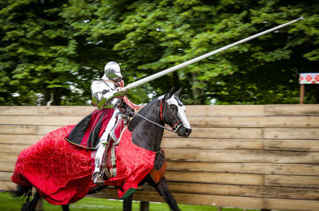战斗装甲骑在马背上的装甲骑士在一场战斗中冲锋照片