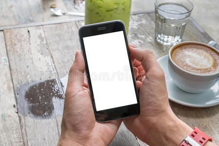 关闭一个人使用智能手机与空白手机和一杯咖啡。智能手机与空白屏幕，可以添加您的文本