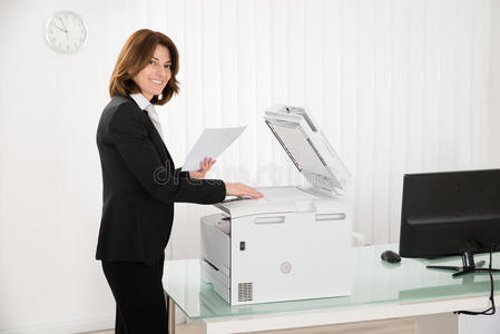 女商人用复印机复印纸张