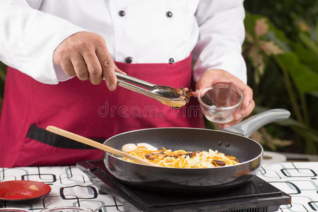 厨师把蘑菇放在锅里