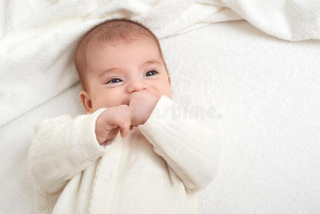 婴儿肖像躺在床上的白色毛巾上
