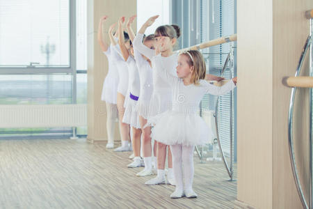 一群七个小芭蕾舞演员站在一起练习