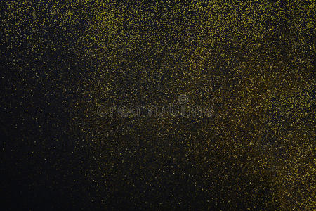 金色闪光的沙子纹理在黑色，抽象的背景。