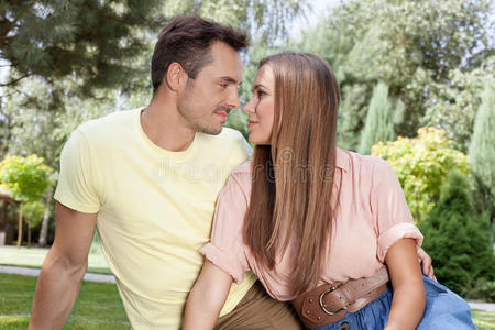 浪漫的年轻情侣在公园里互相凝视