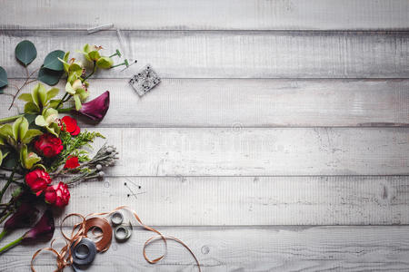 白色桌子边的花胼胝体康乃馨和丝带